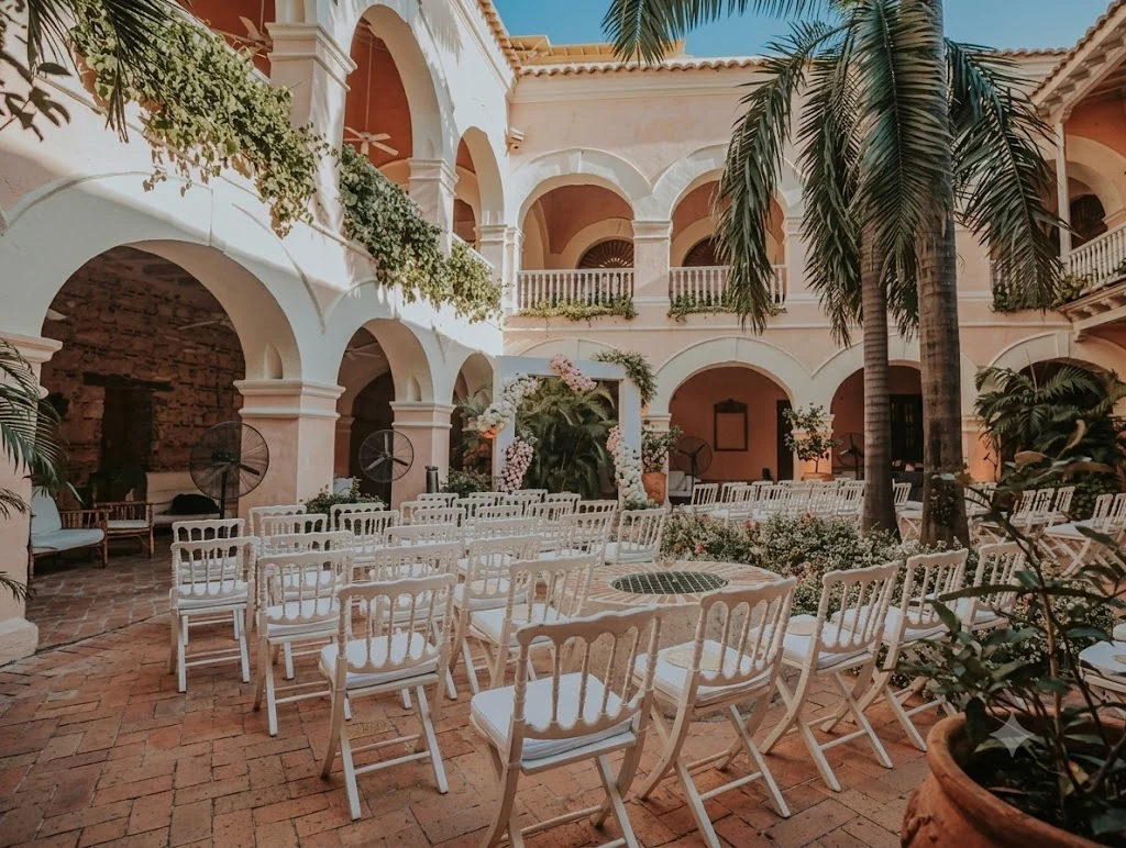 Sillas blancas y montaje de ceremonia en un patio colonial de Cartagena